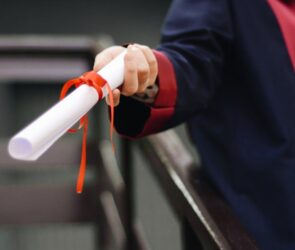 Free Person Holding White Scroll Stock Photo