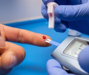 Closeup shot of a doctor with rubber gloves taking a blood test from a patient