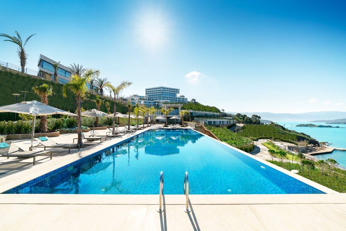 Free A luxurious seaside resort in Bodrum, Turkey, featuring a stunning infinity pool under sunny skies. Stock Photo